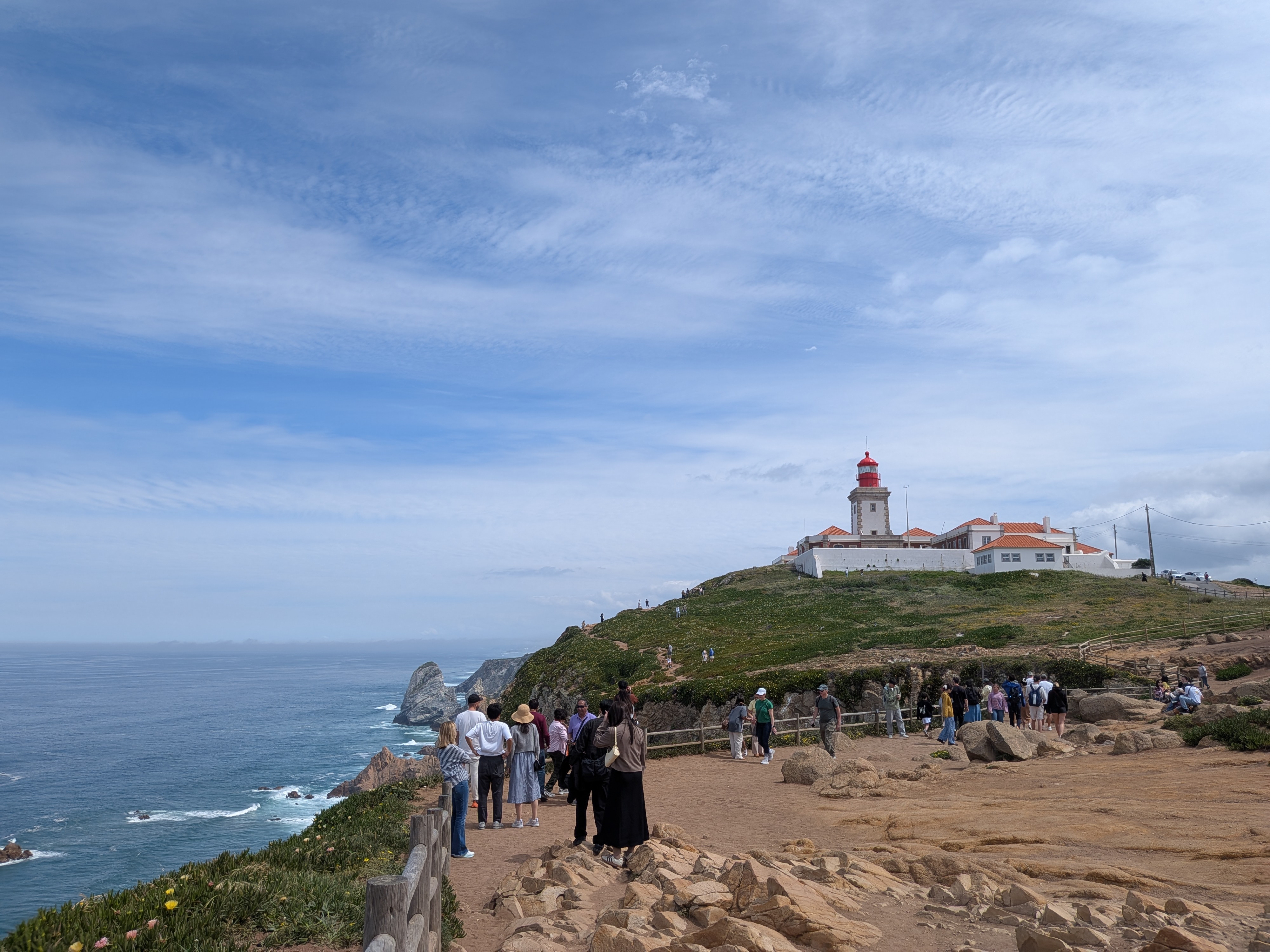 Cabo da Roca coastline with people walking by the lighthouse